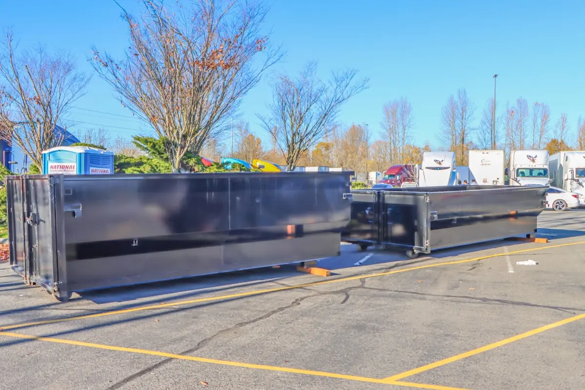 Professional dumpster rental service with roll-off container on residential driveway in Middle River